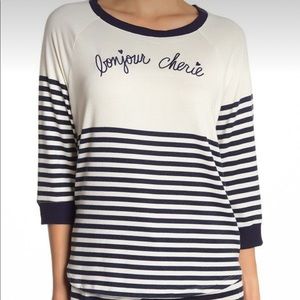 French theme top says Bonjour Cherie by Room Service is NWT. Size Medium